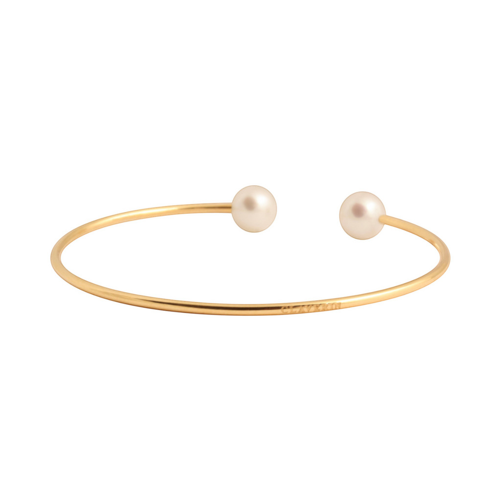 Bracelet jonc souple Claverin en or jaune 18 carats orné de deux perles blanches élégantes